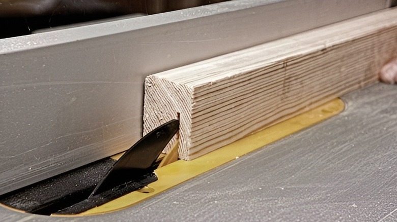 Closeup of table saw blade going into wood