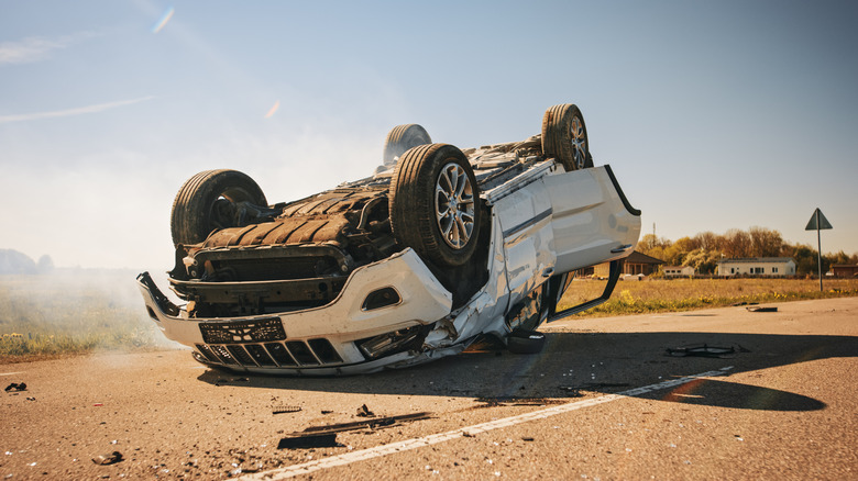 A white Jeep SUV rolled on its roof.