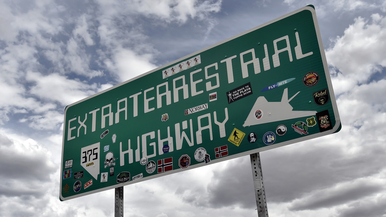 An Extraterrestrial Highway sign against a cloudy sky.