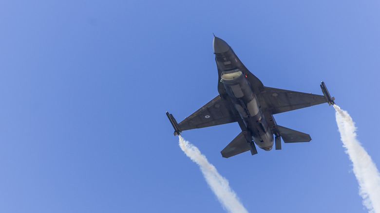 A Hellenic Air Force F-16 Fighting Falcon flying at speed with vortices coming off each wing