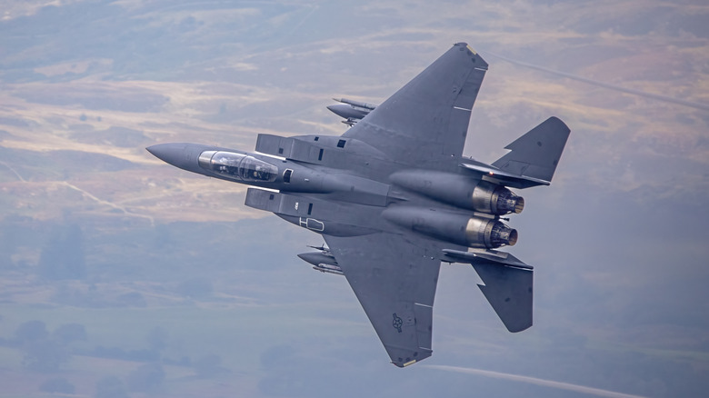 A USAF F-15 Strike Eagle banking left, photographed from below