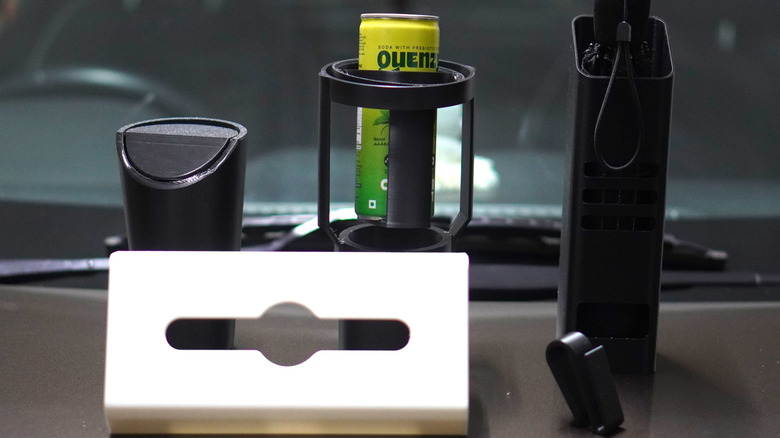 Five 3D-printed car accessories on a car's bonnet.