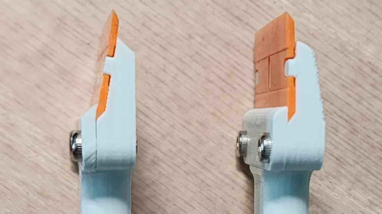 A bed scraper with removable blades on a table