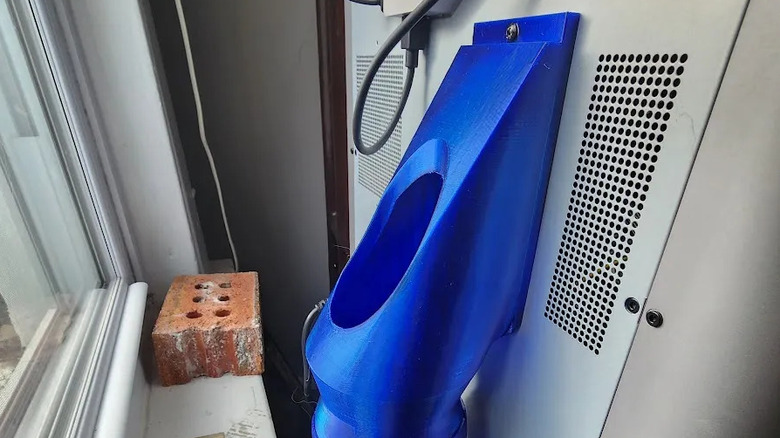 Junk shoot tube on the back of a 3D printer