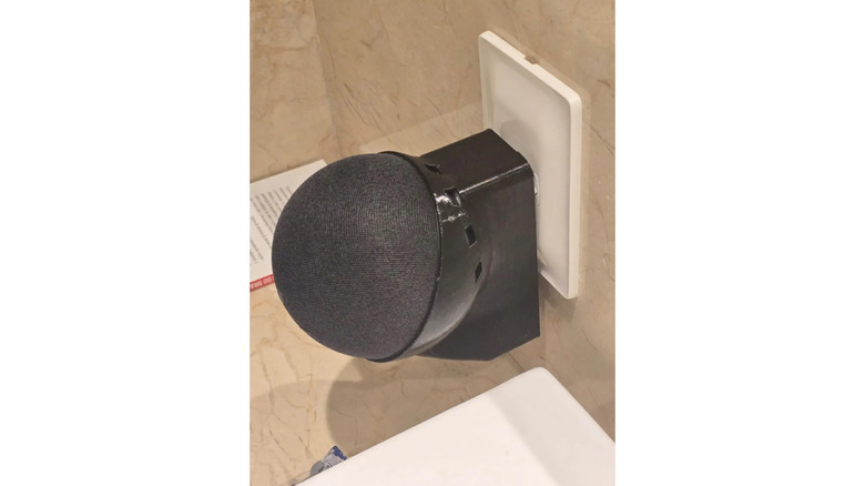 An Amazon Echo Dot mounted on a 3D-printed socket holder