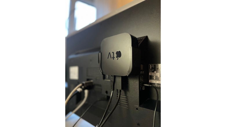 An Apple TV 4K mounted behind a TV using a 3D-printed enclosure