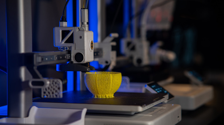 A 3D printer printing an object with yellow filament