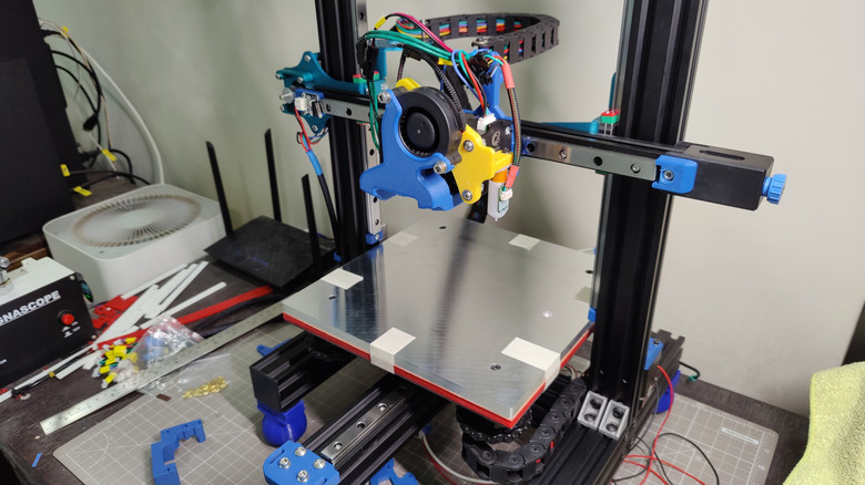 Mechanical and electrical upgrades being applied to a 3D printer