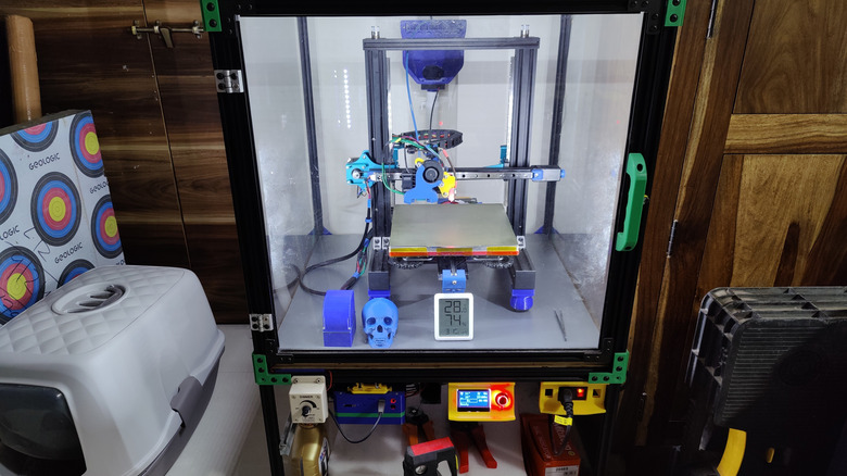 Enclosed 3D printer alongside safety equipment