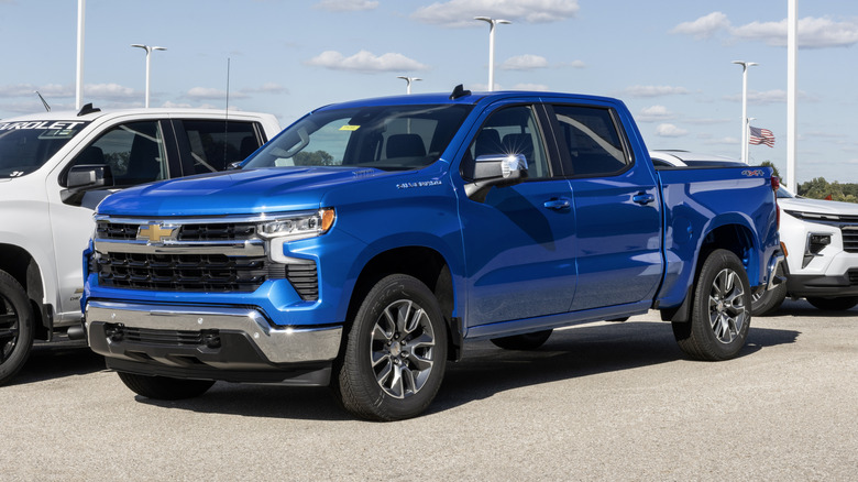 A blue Chevrolet Silverado parked outside.