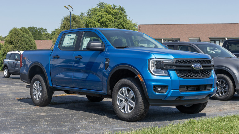 A blue Ford Ranger pickup truck parked outside.