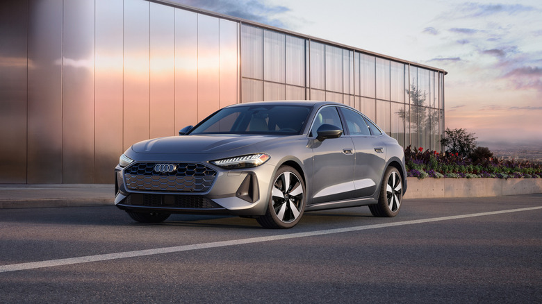 2025 Audi A5 in gray outside a modern home, front 3/4 view, gray exterior, North American spec