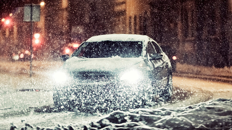 A sedan driving on an icy road