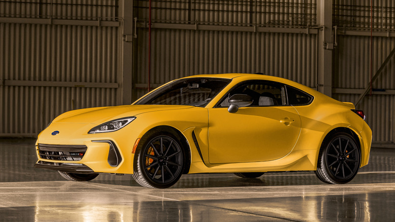 Front 3/4 view of Subaru BRZ parked in a hangar