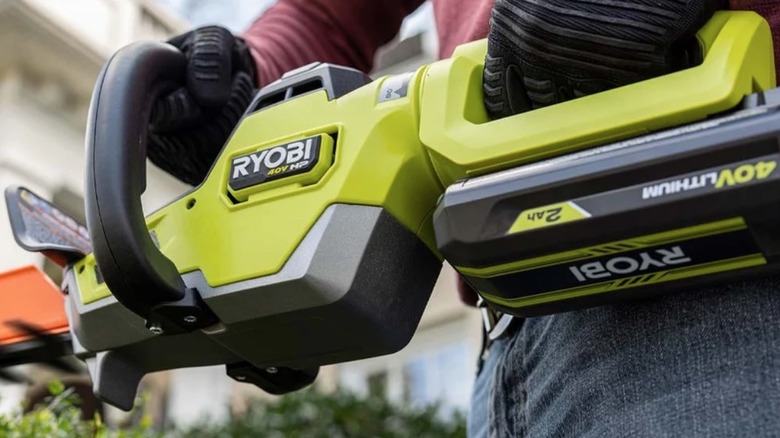 Person using a Ryobi 40V battery to power a tool