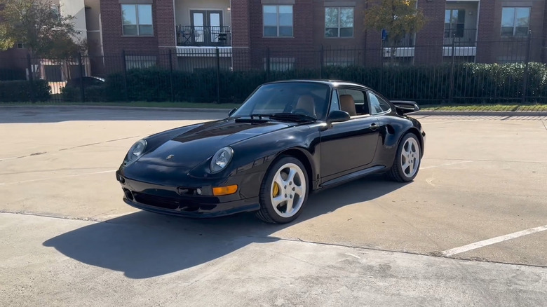 A side on shot of a black 1997 Porsche 911 Turbo S