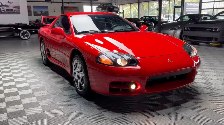 A side on shot of a red 1999 Mitsubishi 3000 GT VR4