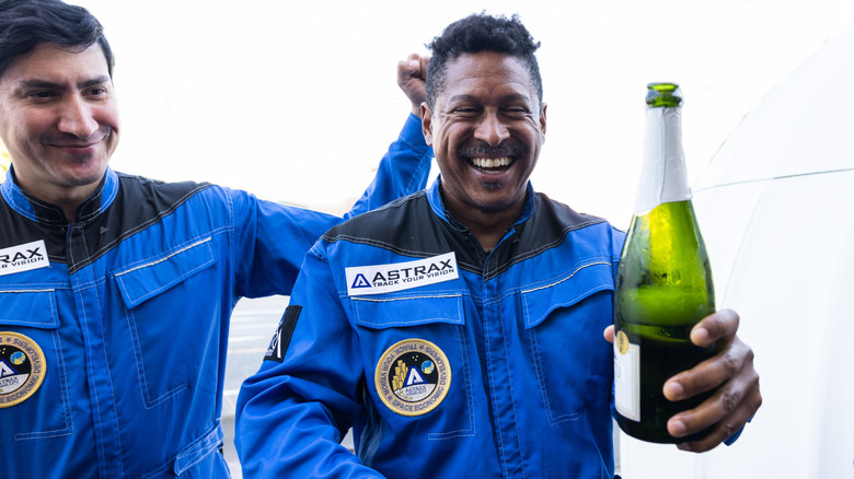 Commercial space travelers celebrate the return to earth with a bottle of champagne.