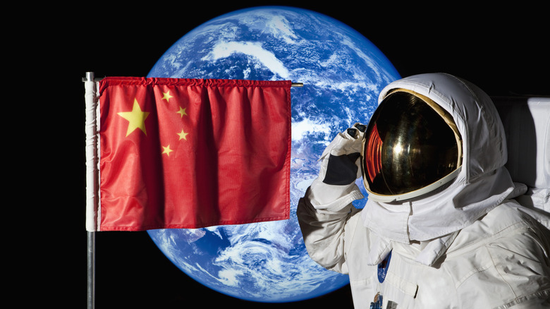An astronaut in space with a Chinese flag and the Earth in the background.