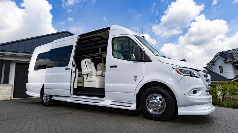 OGV Sprinter V-Cruise in front of a house with the sliding door open.