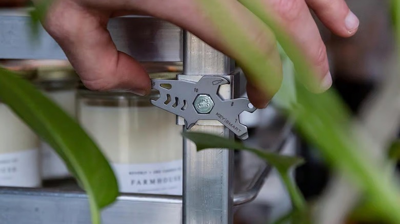 KeySmart shark being used to unscrew a bolt