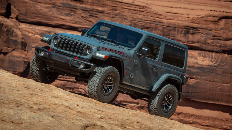 Gray Jeep Wrangler parked on a mountain slope