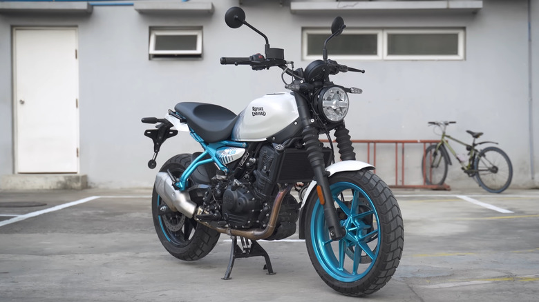 A 2025 Brava Blue Royal Enfield Guerrilla 450 parked in a parking lot