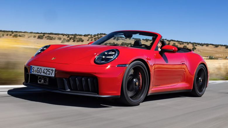 A red Porsche 911 Cabriolet driving