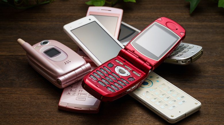 Old flip phones on a table