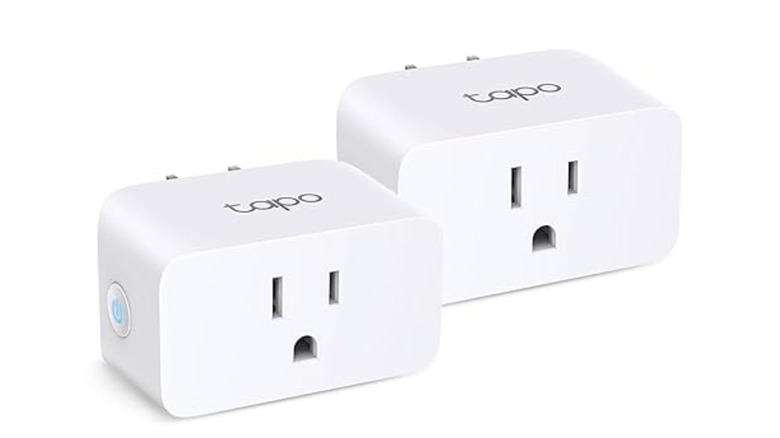Two white smart plugs isolated against a white background