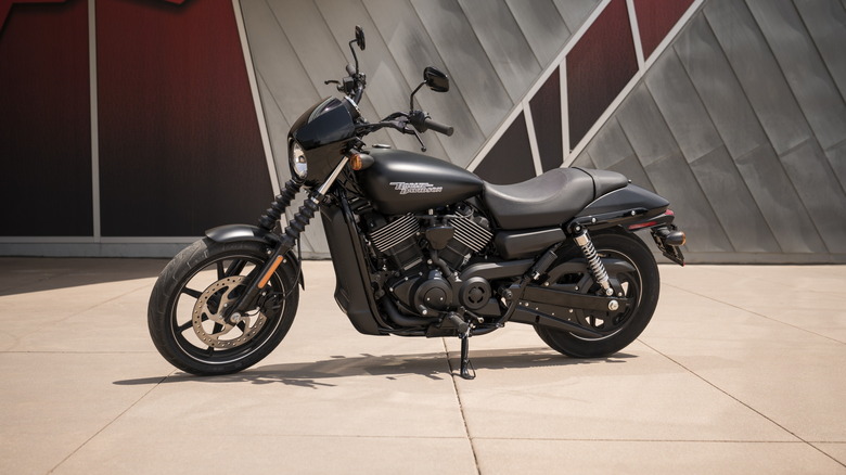 A black and silver 2019 Harley Davidson Street 750 parked, facing left in front of a wall