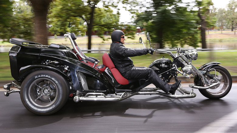 A black Harley-Davidson trike in a park in Melbourne, Australia