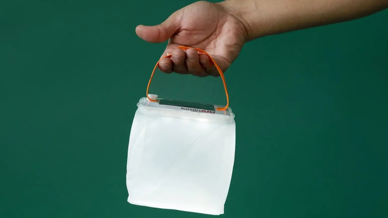LuminAID lantern being held by strap