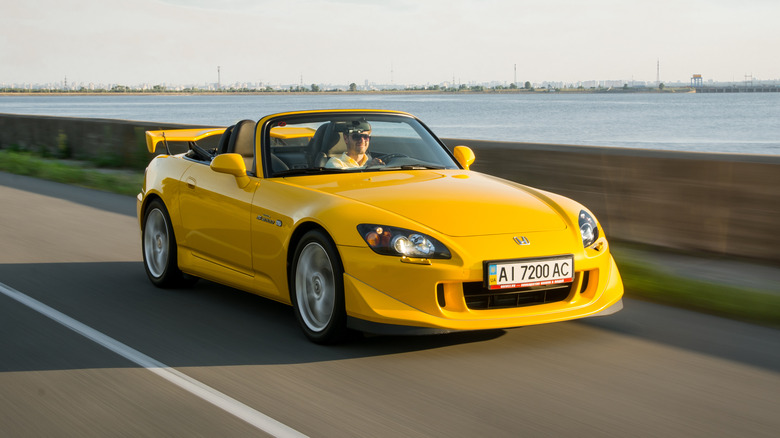 yellow Honda S2000 highway driving