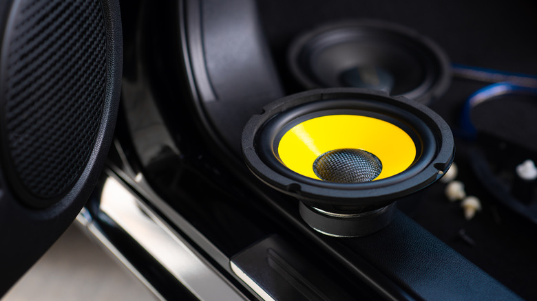 Yellow subwoofer speaker in car audio system 