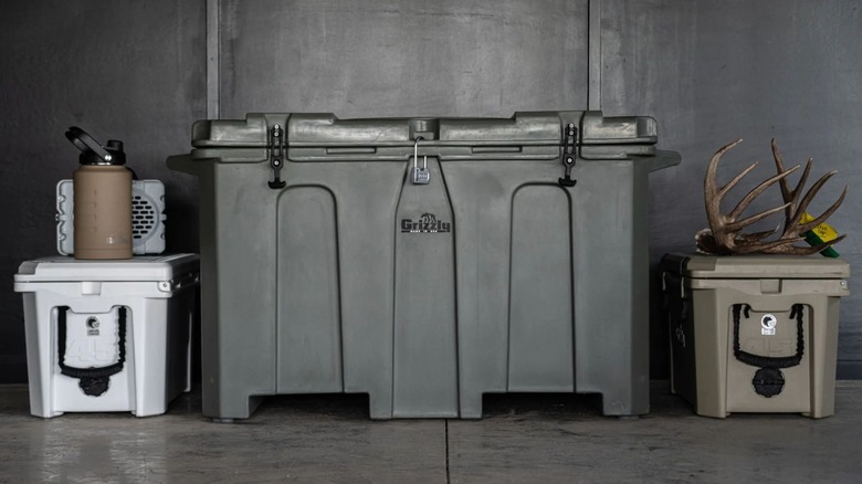 large gray grizzly cooler between two small coolers