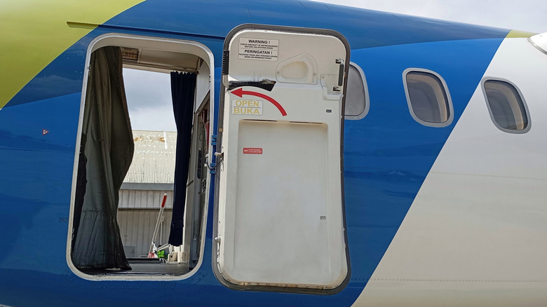 Blue and white plane with door open
