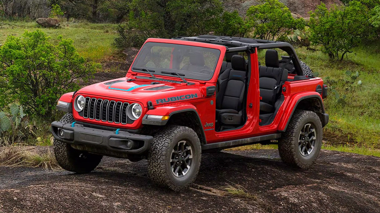 A red 2025 Jeep Rubicon X parked in the wilderness