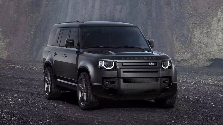A black 2025 Land Rover Defedner 130 driving