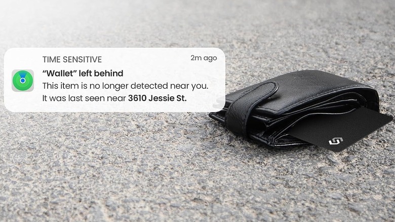 An iPhone alert overlaid on a black wallet laying on a carpet with a SPOTMINDERS tracking card sticking out of the top