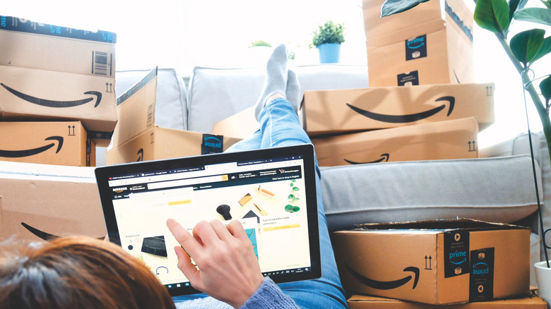 stack of amazon packages and shopper