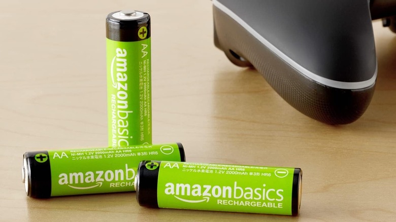 Three Amazon Basics Rechargeable High-Capacity AA Batteries beside a game controller