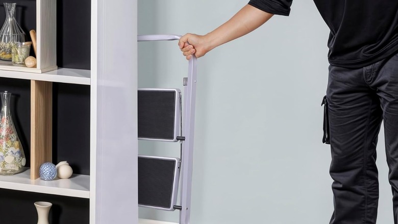 man holding foldable ladder