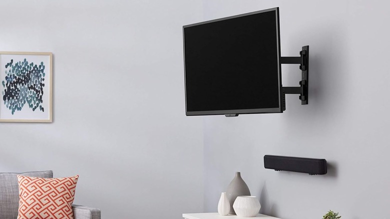 A TV mounted with Amazon Basics Full Motion Wall Mount in a home.