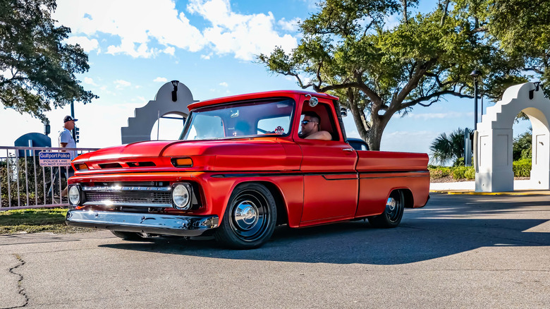 Front 3/4 shot of a red Chevrolet C10 lowrider