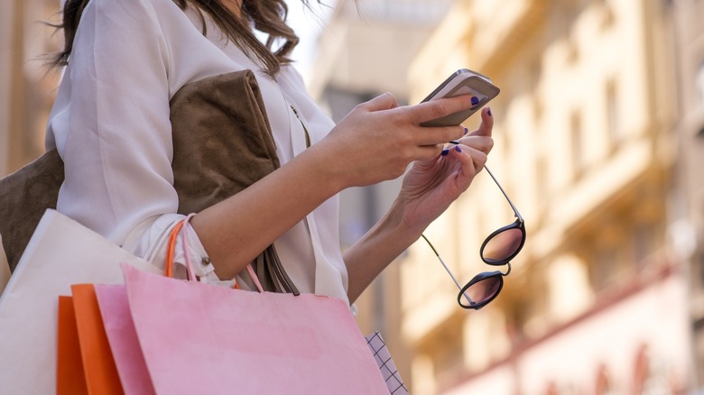 Woman shopping and using a phone