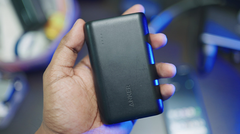 Person holding an Anker power bank.
