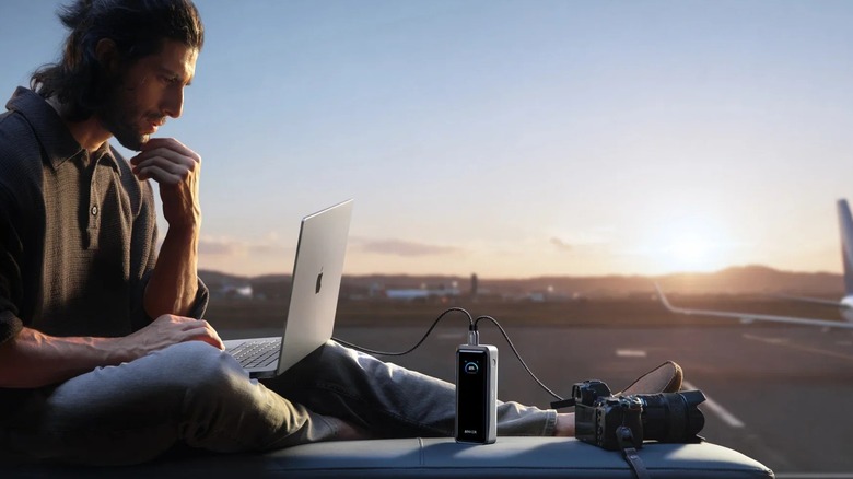 Person using Anker products to charge devices while traveling