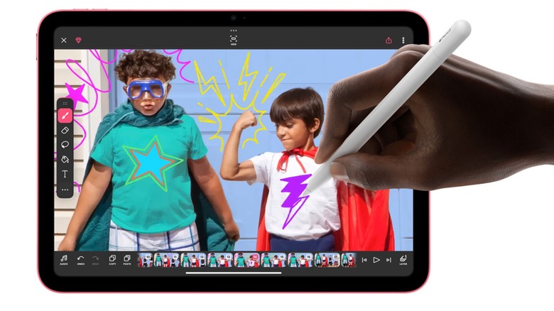 A person drawing on their iPad using an Apple Pencil