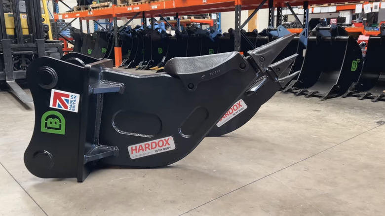 A close up of a row of backhoe rippers